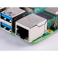 Close-up of a computer motherboard with Ethernet connector and USB ports.