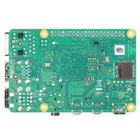 Green electronic circuit board with various components on a white background